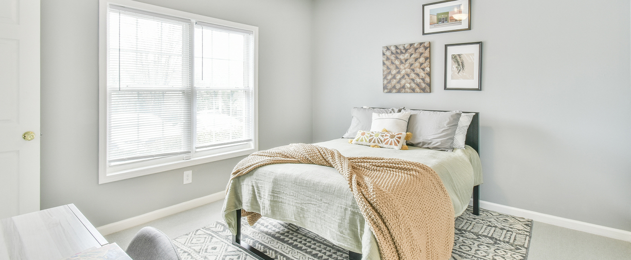 Furnished bedroom with a large window