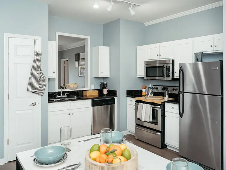 Apartment kitchen and dining area with stainless steel appliances