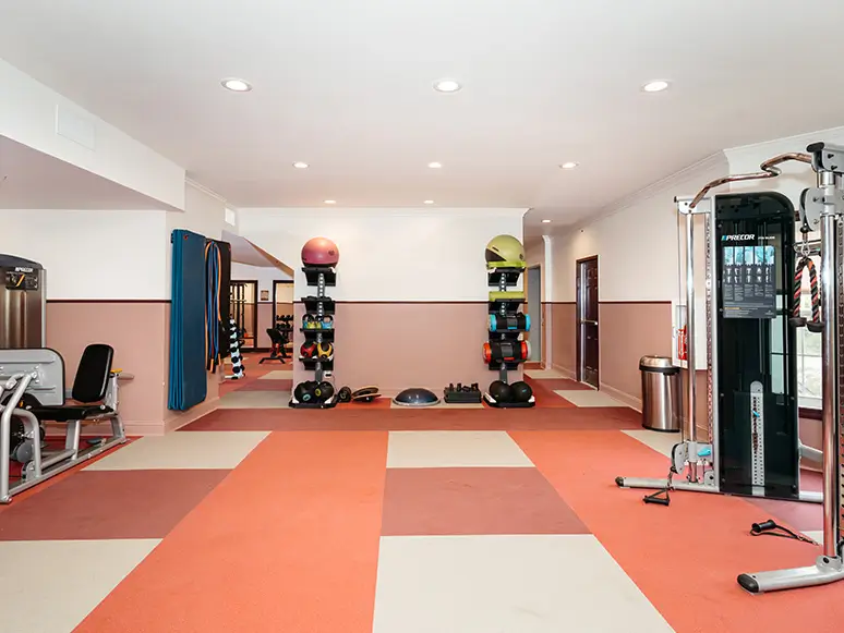 Fitness center with a cable machine and dumbbell rack