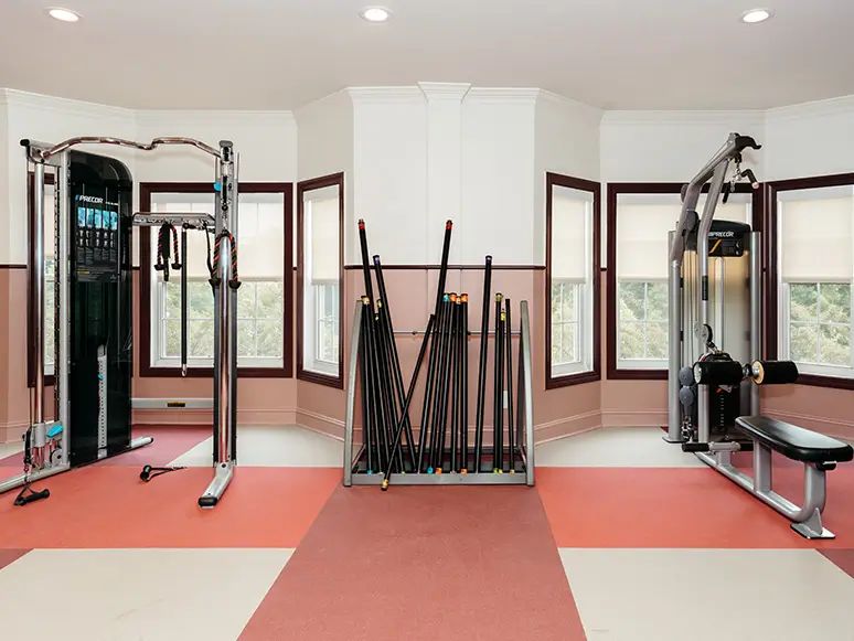 Fitness center with cable machines and a barbell rack