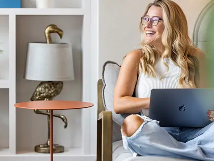 Resident smiling while working on a laptop