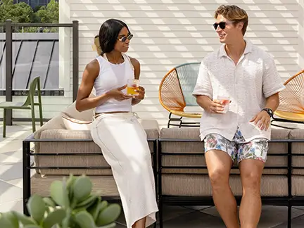 Two friends talking on an outdoor patio