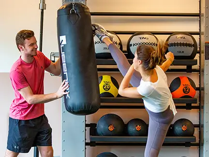 Two residents working out with a punching bag
