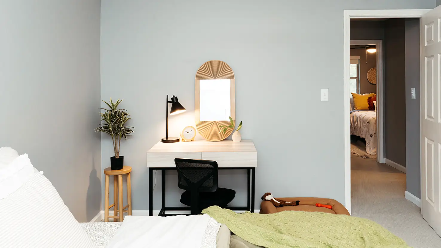 Bedroom desk with a lamp and arched mirror