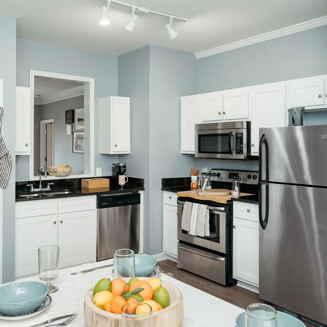 Apartment kitchen and dining area with stainless steel appliances