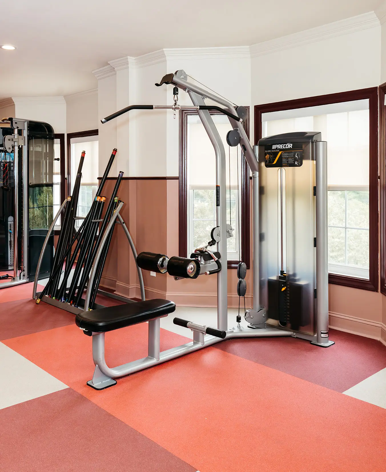 Fitness center with a cable machine and barbell rack