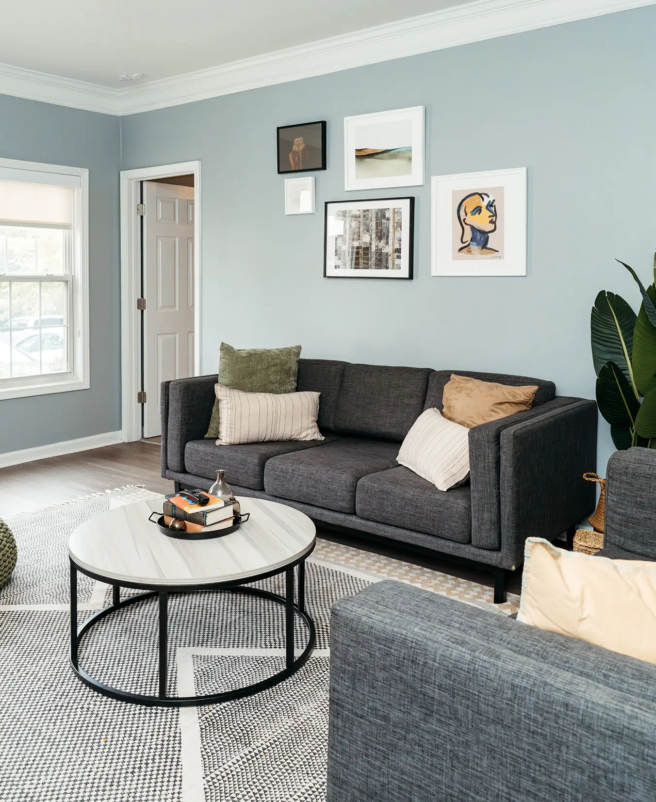 Furnished living room with a gray sofa and framed art