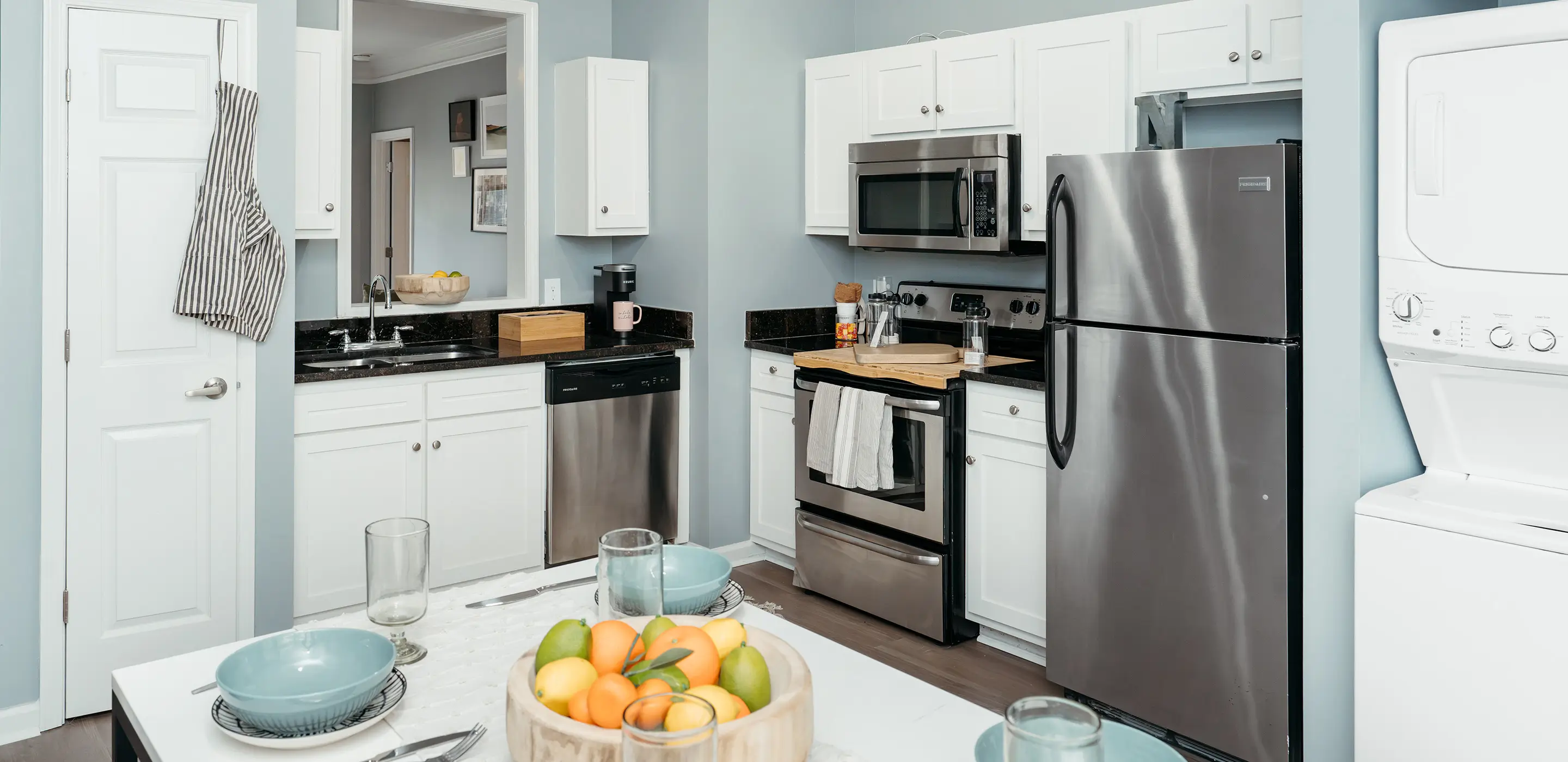 Apartment kitchen and dining area with stainless steel appliances